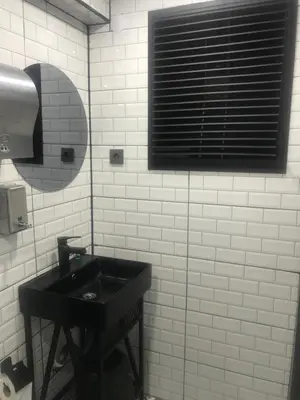 a bathroom with a black sink and a window at Hotel Hoyuk in Istanbul