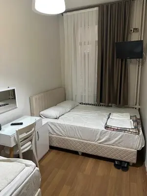 a small room with a bed and a desk and a bed at Hotel Hoyuk in Istanbul