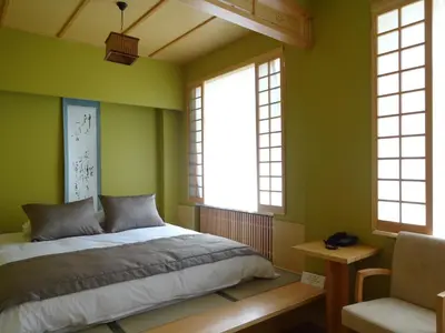 a bedroom with green walls and a bed and a chair at Bunkahaus in Istanbul