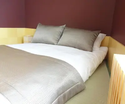 a bed with white sheets and pillows in a room at Bunkahaus in Istanbul
