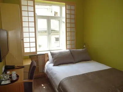 a small bedroom with a bed and a window at Bunkahaus in Istanbul