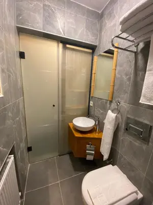 a bathroom with a sink and a toilet and a mirror at Bunkahaus in Istanbul