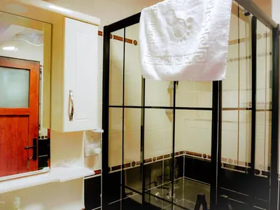 a bathroom with a shower with a towel hanging at Family apartment in Istanbul