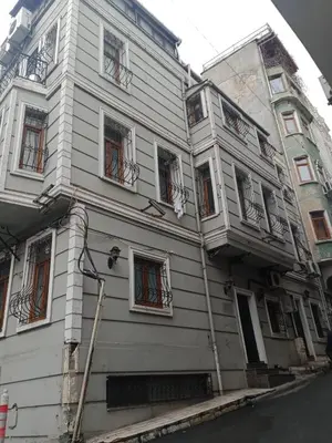 a white building with many windows on a street at Family apartment in Istanbul