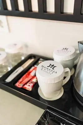 a stove top with two cups on a tray at Monezza Maltepe Rezidans in Istanbul