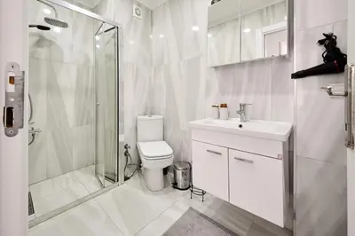 a bathroom with a toilet and a shower and a sink at Cozy Oasis in Moda Steps to Seafront in Istanbul