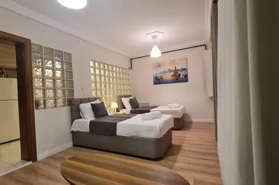 a bedroom with two beds and a couch at Cozy 2 bedroom near Green Mosque in Yıldırım