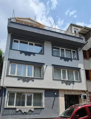 a white building with windows on the side of it at Cozy 2 bedroom near Green Mosque in Yıldırım