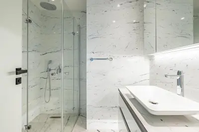 a white bathroom with a shower and a sink at Beautiful Bright Deluxe 1BD Condo PoolViews! #311 in Istanbul