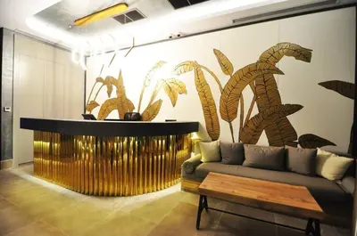 a living room with a couch and a wall with plants at Beautiful Bright Deluxe 1BD Condo PoolViews! #311 in Istanbul