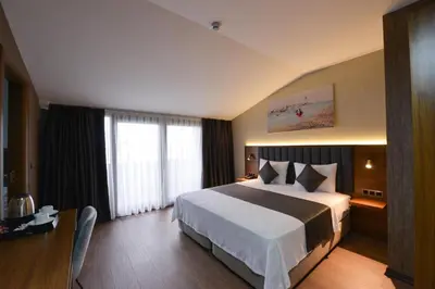 a hotel room with a large bed and a window at İSTPORT GARDEN HOTELS in Arnavutköy