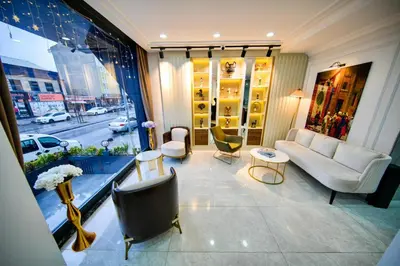a living room with a couch and chairs and a window at İSTPORT GARDEN HOTELS in Arnavutköy