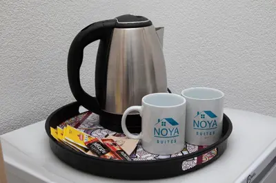 a black tray with two mugs and a tea kettle at Noya Suites in Istanbul