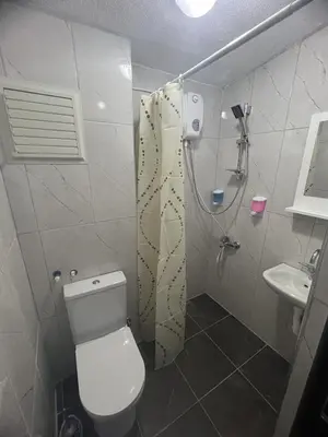a small bathroom with a toilet and a sink at Noya Suites in Istanbul