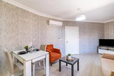 a living room with a table and a couch and a chair at The Canka Residence And Family Apartment Istanbul City Center - ŞIŞLI in Istanbul