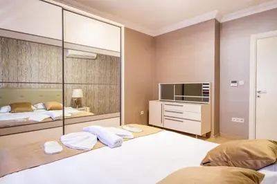 a bedroom with two beds and a flat screen tv at The Canka Residence And Family Apartment Istanbul City Center - ŞIŞLI in Istanbul