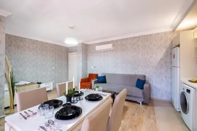 a kitchen and living room with a table and chairs at The Canka Residence And Family Apartment Istanbul City Center - ŞIŞLI in Istanbul