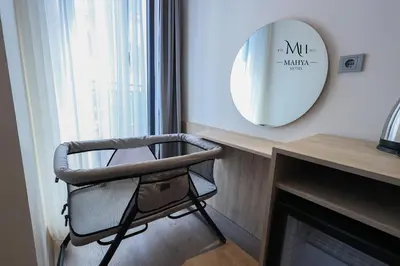 a chair in front of a mirror next to a fireplace at Mahya Hotel in Istanbul