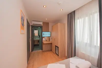 a room with a bed and a tv in a room at Mahya Hotel in Istanbul