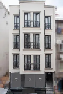 a white building with black windows and balconies at Mahya Hotel in Istanbul