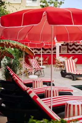 a group of chairs and umbrellas in a patio at Büyükada Splendid Palace Hotel in Buyukada