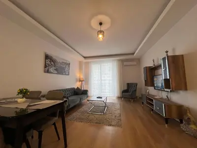 a living room with a couch and a table at Cozy Homes 1 Room 1 Living room Apartment in Esenyurt