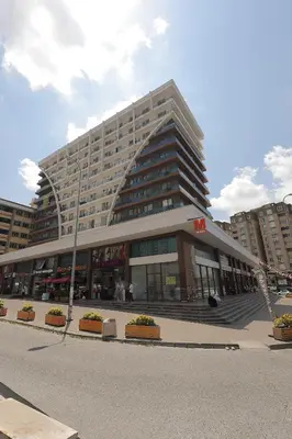 a large building in front of a street at Cozy Homes 1 Room 1 Living room Apartment in Esenyurt