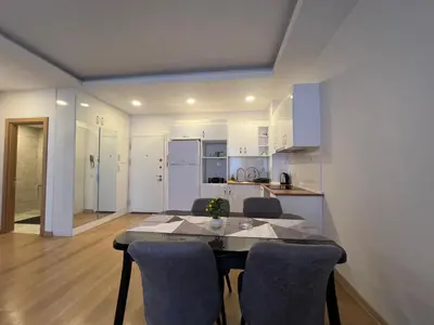 a kitchen and dining room with a table and chairs at Cozy Homes 1 Room 1 Living room Apartment in Esenyurt
