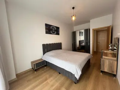 a bedroom with a bed and a wooden floor at Cozy Homes 1 Room 1 Living room Apartment in Esenyurt