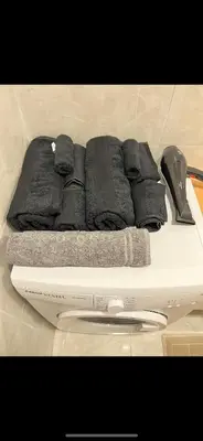 a white scale with towels on top of it at Cozy Homes 1 Room 1 Living room Apartment in Esenyurt