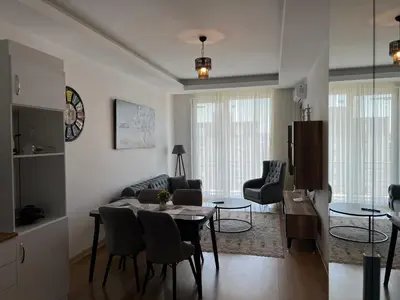 a kitchen and living room with a table and chairs at Central Location Free WIFI AC Parking Garage in Esenyurt