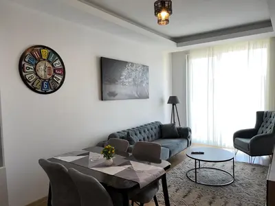 a living room with a couch and a table at Central Location Free WIFI AC Parking Garage in Esenyurt