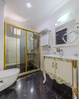 a bathroom with a tub and a sink and a shower at Lemis Suite Istanbul in Istanbul