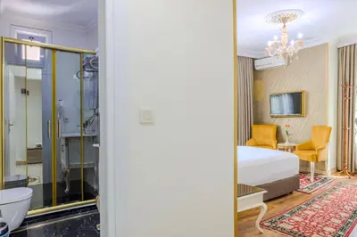 a hotel room with a bed and a bathroom at Lemis Suite Istanbul in Istanbul