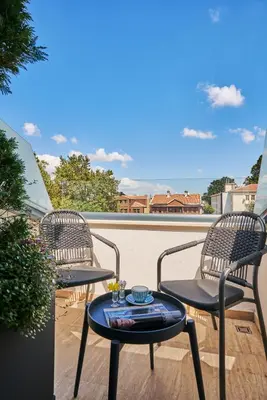 a patio with two chairs and a table on a balcony at Rayelin Hotel Istanbul Old City in Istanbul