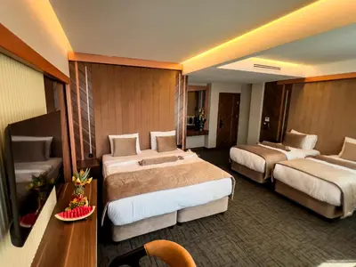 a hotel room with two beds and a table at THE PARK HOTEL in Istanbul