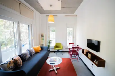 a living room with a blue couch and a table at İstanbul Smart Apart by SUMMITVISTA in Istanbul