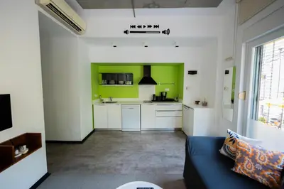 a living room with green walls and a blue couch at İstanbul Smart Apart by SUMMITVISTA in Istanbul
