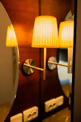 a pair of lamps sitting on a mirror at İstanbul Smart Apart by SUMMITVISTA in Istanbul