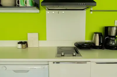 a kitchen with green walls and a counter top at İstanbul Smart Apart by SUMMITVISTA in Istanbul
