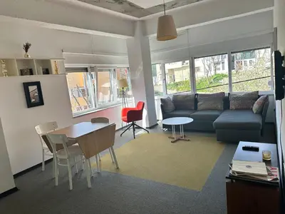 a living room with a couch and a table and chairs at İstanbul Smart Apart by SUMMITVISTA in Istanbul