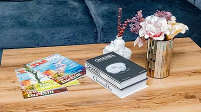a table with two books and a vase with flowers at Elite Marmara Bosphorus Çamlıca in Istanbul