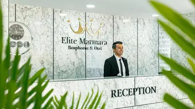 a man in a suit in front of a mirror at Elite Marmara Bosphorus Çamlıca in Istanbul