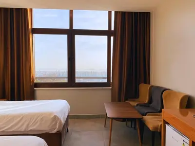 a hotel room with a bed and a desk and a window at Elite Marmara Bosphorus Çamlıca in Istanbul