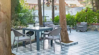 a table and chairs and trees on a patio at Elite Marmara Bosphorus Çamlıca in Istanbul
