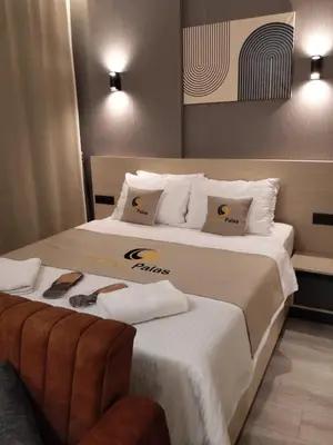 a hotel room with two beds with towels on them at Doğan Palace Hotel in Istanbul