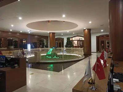 a lobby with a christmas tree in the middle at Doğan Palace Hotel in Istanbul