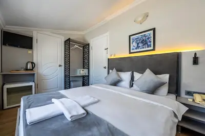 a bedroom with a large bed with two towels at Taksim Trust Hotel in Istanbul