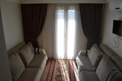 a living room with two couches and a large window at New Fatih Hotel in Istanbul