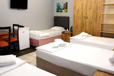 a room with three beds and a tv in it at Avist Hotel Avcılar in Avcılar